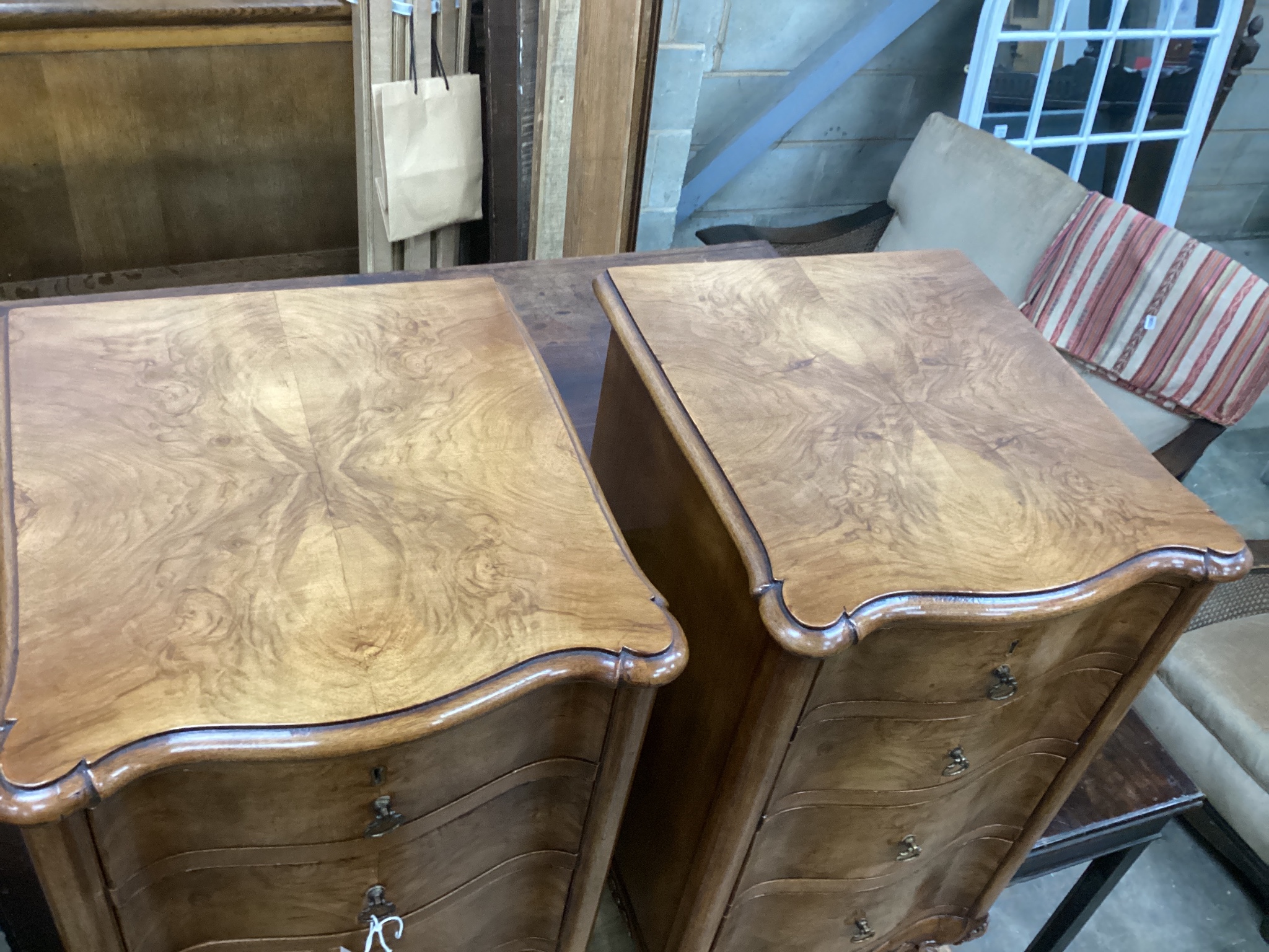 A pair of Queen Anne revival walnut serpentine four drawer bedside chests, width 38cm, depth 43cm, height 70cm